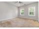 Bright bedroom with neutral walls, carpet and a ceiling fan at 2461 Sycamore Nw Rd, Atlanta, GA 30318