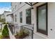 Inviting townhouse entryway with black trim, modern door, and wrought iron railing, showcasing the home's curb appeal at 2461 Sycamore Nw Rd, Atlanta, GA 30318