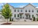 Modern townhome with white brick and siding, black framed windows, and stylish wrought iron railings at 2461 Sycamore Nw Rd, Atlanta, GA 30318