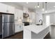 Bright kitchen with a large island, stainless steel appliances, and sleek white cabinets at 2461 Sycamore Nw Rd, Atlanta, GA 30318