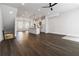 Open-concept living space with hardwood flooring, kitchen island, and staircase access at 2461 Sycamore Nw Rd, Atlanta, GA 30318