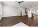 Open-concept living space with hardwood floors, modern lighting, and seamless transition to the kitchen and stairs at 2461 Sycamore Nw Rd, Atlanta, GA 30318