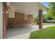Covered porch features brick columns, concrete floors, and views of the landscaped yard at 2790 Laurel Ridge Dr, Decatur, GA 30033