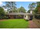 Backyard of the home featuring a lush green lawn and mature trees at 2790 Laurel Ridge Dr, Decatur, GA 30033