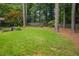 Large backyard with mature trees, lush green grass, and privacy fence at 2790 Laurel Ridge Dr, Decatur, GA 30033