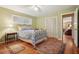 Bright bedroom features hardwood floors, closet, and metal bed frame with stylish bedding at 2790 Laurel Ridge Dr, Decatur, GA 30033