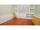 Bright bedroom with built-in shelving, wood floors, wainscoting, and a large window at 2790 Laurel Ridge Dr, Decatur, GA 30033