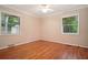 Bright bedroom with hardwood floors, ceiling fan, and two windows providing plenty of natural light at 2790 Laurel Ridge Dr, Decatur, GA 30033