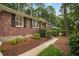 A close up of a brick home featuring crisp white window trim and meticulous landscaping at 2790 Laurel Ridge Dr, Decatur, GA 30033