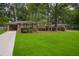 Expansive front yard with lush green grass leads to a beautiful brick home surrounded by mature trees at 2790 Laurel Ridge Dr, Decatur, GA 30033