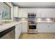 Well-equipped kitchen showcasing stainless steel appliances and pristine white cabinetry for a clean, modern look at 2790 Laurel Ridge Dr, Decatur, GA 30033
