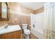 Small bathroom featuring a shower/tub combo, white toilet, wood vanity, and tile walls at 327 Red Fox Dr, Canton, GA 30114