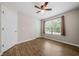 Simple bedroom with ceiling fan, window, and wood floors at 327 Red Fox Dr, Canton, GA 30114