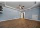 Bonus room with tray ceiling, wood floors, and light blue walls at 327 Red Fox Dr, Canton, GA 30114