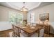 Inviting dining room with wood table, decorative chandelier, and natural light from a large window at 327 Red Fox Dr, Canton, GA 30114