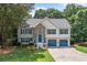 Charming two-story home featuring stone accents, blue shutters, and a well-manicured lawn at 327 Red Fox Dr, Canton, GA 30114