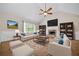 Bright living room features a fireplace, ceiling fan, built-in bookshelves, and comfortable seating at 327 Red Fox Dr, Canton, GA 30114