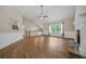 Open living room boasts beautiful wood flooring, a stone fireplace, and natural light from large windows at 327 Red Fox Dr, Canton, GA 30114
