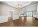Open concept living and dining area features wood flooring, neutral walls, and modern lighting at 327 Red Fox Dr, Canton, GA 30114
