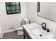 Bright bathroom with marble countertops, wood-look flooring, and a black trimmed window at 3530 Turner Heights Dr, Decatur, GA 30032