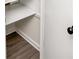 Organized pantry space featuring light wood grain flooring and ample white shelving for optimal storage at 3530 Turner Heights Dr, Decatur, GA 30032