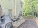 Back patio featuring outdoor seating and barbecue grill, surrounded by natural shade at 1311 Primrose View Cir, Lawrenceville, GA 30044