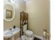Half bathroom with a pedestal sink, modern fixtures, and decorative accents at 1311 Primrose View Cir, Lawrenceville, GA 30044