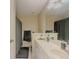 Bathroom with a double sink vanity, large mirror, great lighting and bathtub shower at 1311 Primrose View Cir, Lawrenceville, GA 30044