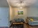 Cozy dining area with a table, seating, a sofa, and contemporary lighting at 1311 Primrose View Cir, Lawrenceville, GA 30044