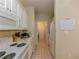 Efficient kitchen with white appliances, ample counter space, and access to laundry at 1311 Primrose View Cir, Lawrenceville, GA 30044