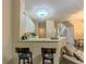 Bright kitchen with breakfast bar, white cabinets and views to living space at 1311 Primrose View Cir, Lawrenceville, GA 30044
