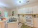 Functional kitchen featuring ample counter space, white appliances, and a garden view at 1311 Primrose View Cir, Lawrenceville, GA 30044