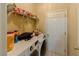 Functional laundry room with modern washer/dryer, storage shelves, and tile flooring at 1311 Primrose View Cir, Lawrenceville, GA 30044