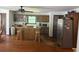 Open concept kitchen with island, stainless steel refrigerator and vintage cabinetry at 408 Hasty Trl, Canton, GA 30115