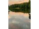 View of a serene lake at sunset with dock at 408 Hasty Trl, Canton, GA 30115