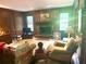 A spacious living room with wooden walls, a fireplace, and plush seating at 408 Hasty Trl, Canton, GA 30115