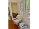 Cozy sunroom corner featuring wicker furniture, a sink, and lots of natural light at 408 Hasty Trl, Canton, GA 30115