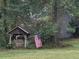 Rustic well house with an American flag flying on lush green property at 408 Hasty Trl, Canton, GA 30115