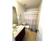 Bathroom featuring a single sink vanity, toilet, and shower with curtain at 7178 Glaspie Way, Atlanta, GA 30349