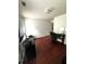 The bedroom is set up as an office with hardwood floors and neutral colored walls at 7178 Glaspie Way, Atlanta, GA 30349