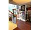 Hallway with hard wood floors, staircase and art on the walls at 7178 Glaspie Way, Atlanta, GA 30349