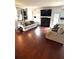 This living room has hardwood floors, a fireplace, and two sofas at 7178 Glaspie Way, Atlanta, GA 30349