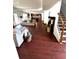Open-concept floorplan featuring the living room, stairs and a glimpse of the kitchen at 7178 Glaspie Way, Atlanta, GA 30349