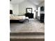 Main bedroom with neutral carpet, fireplace, and large window for natural light at 7178 Glaspie Way, Atlanta, GA 30349