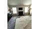 Main bedroom with fireplace, neutral carpet, and large windows for natural light at 7178 Glaspie Way, Atlanta, GA 30349