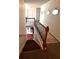 View of staircase with wooden railing and neutral carpet runner at 7178 Glaspie Way, Atlanta, GA 30349