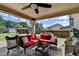 Comfortable patio space with a red sectional couch, ceiling fan, and backyard views at 2410 Melton Common Dr, Dacula, GA 30019
