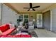 Covered patio with ceiling fan, string lights, comfortable seating, and serene backyard views at 2410 Melton Common Dr, Dacula, GA 30019
