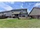 Large backyard with a stone feature, patio area, and ample green space at 2410 Melton Common Dr, Dacula, GA 30019