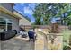 Enjoy this spacious backyard featuring a custom stone fire pit with seating, plus ample lawn area at 2410 Melton Common Dr, Dacula, GA 30019